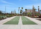 An aerial view shows multiple pickleball courts with blue surfaces and green borders outdoors — 31 HORIZON ROAD, PUNTA GORDA, FL