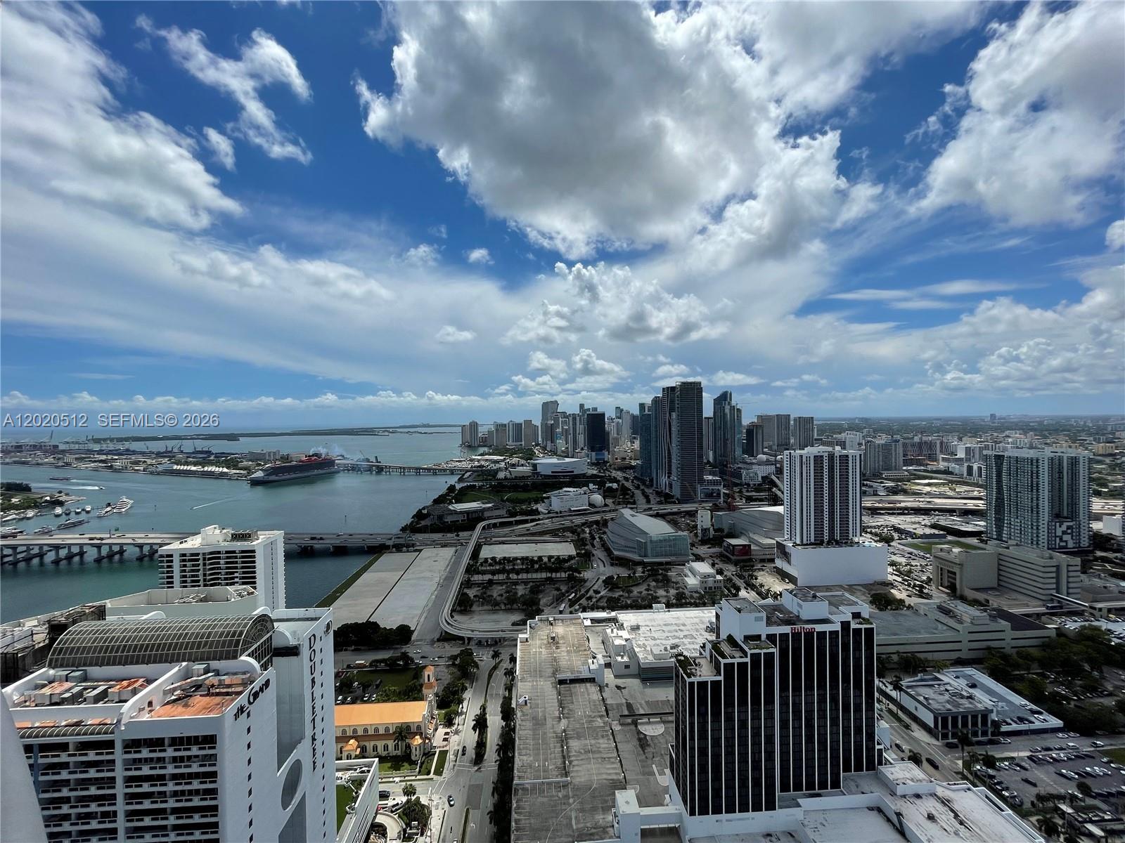 An elevated view of the Miami skyline, waterfront, and cruise ships under a cloudy sky — 1750 N Bayshore Dr # 5614, Miami FL 33132, MIAMI, FL