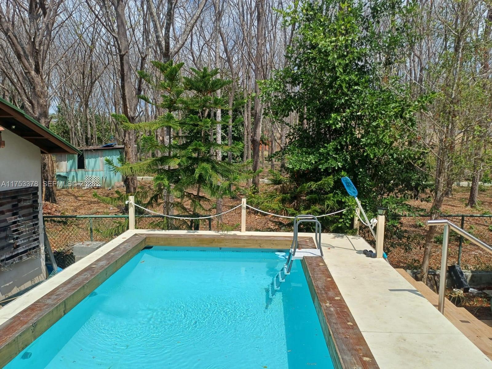 An above-ground rectangular swimming pool with a wooden deck and a metal ladder — San Carlos Panama West Republic of Panama, al, al
