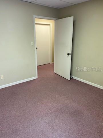 An interior view shows a room with beige walls, purple carpeting, and an open doorway — 1531 TAMIAMI TRAIL S UNIT 8A-8T, VENICE, FL
