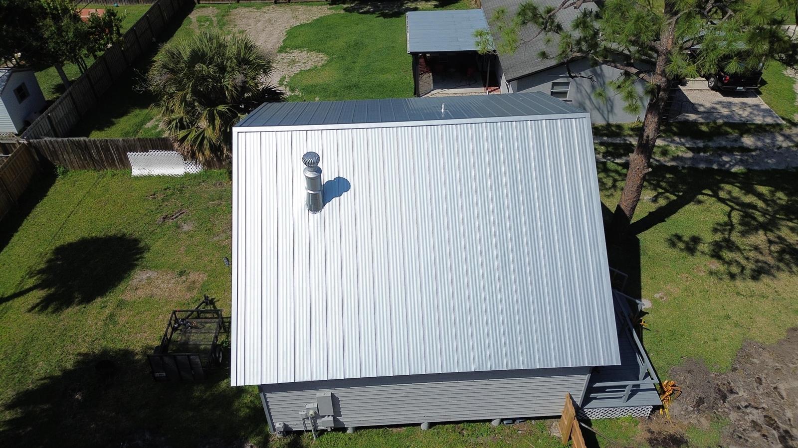 An aerial view of a house with a silver metal roof and a roof vent — 5301 Sunset Boulevard, Fort Pierce FL 34982, FORT PIERCE, FL