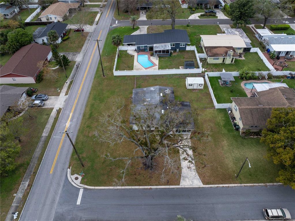 An aerial view shows a single-story house with a large tree in the front yard — 1831 STAUNTON AVENUE, LAKELAND, FL