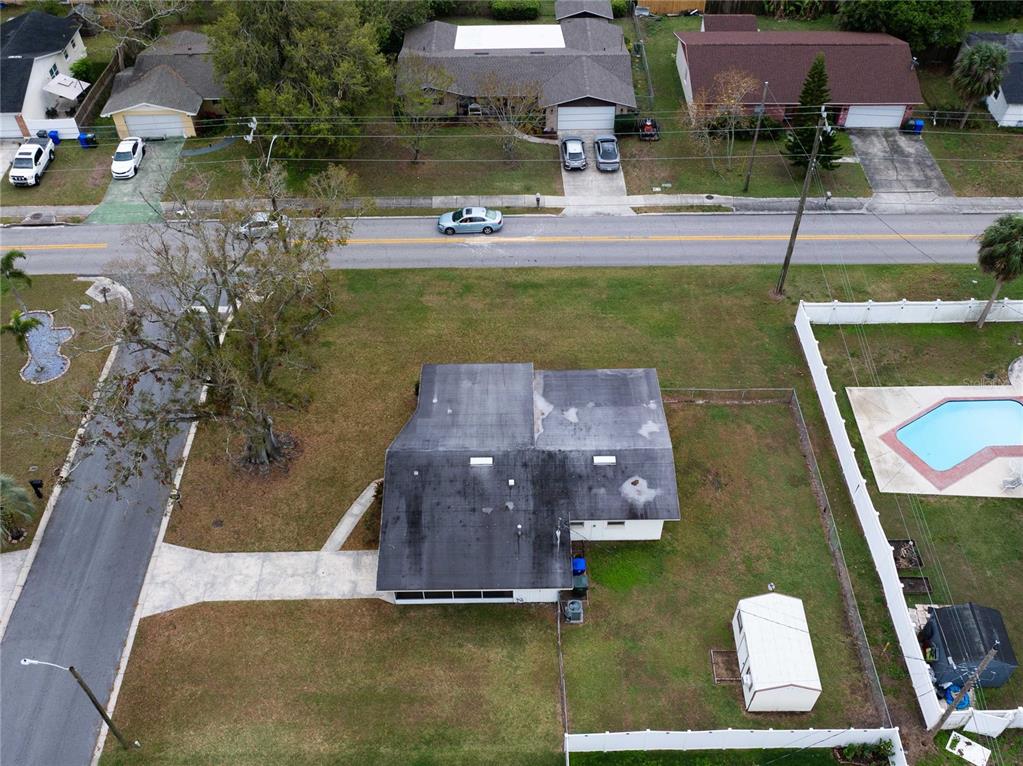 An aerial view shows a house with a large yard, a shed, and a pool — 1831 STAUNTON AVENUE, LAKELAND, FL