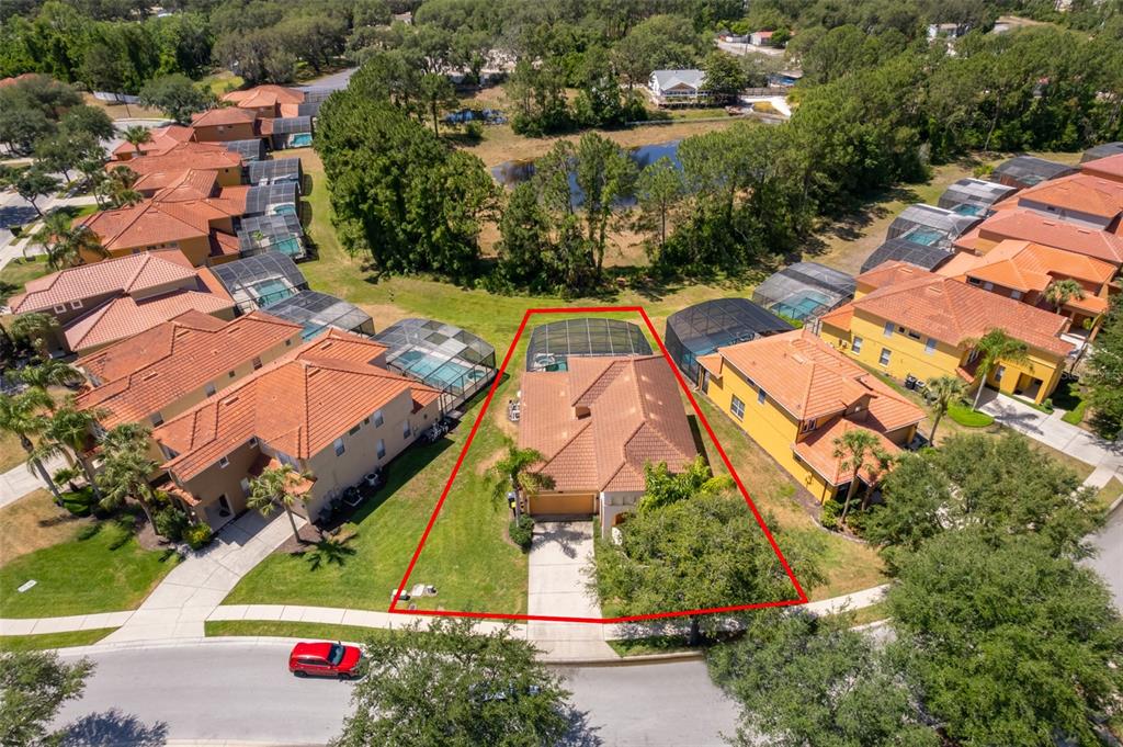 An aerial view shows a single-family home with a screened pool and tile roof — 171 ORANGE COSMOS BOULEVARD, DAVENPORT, FL