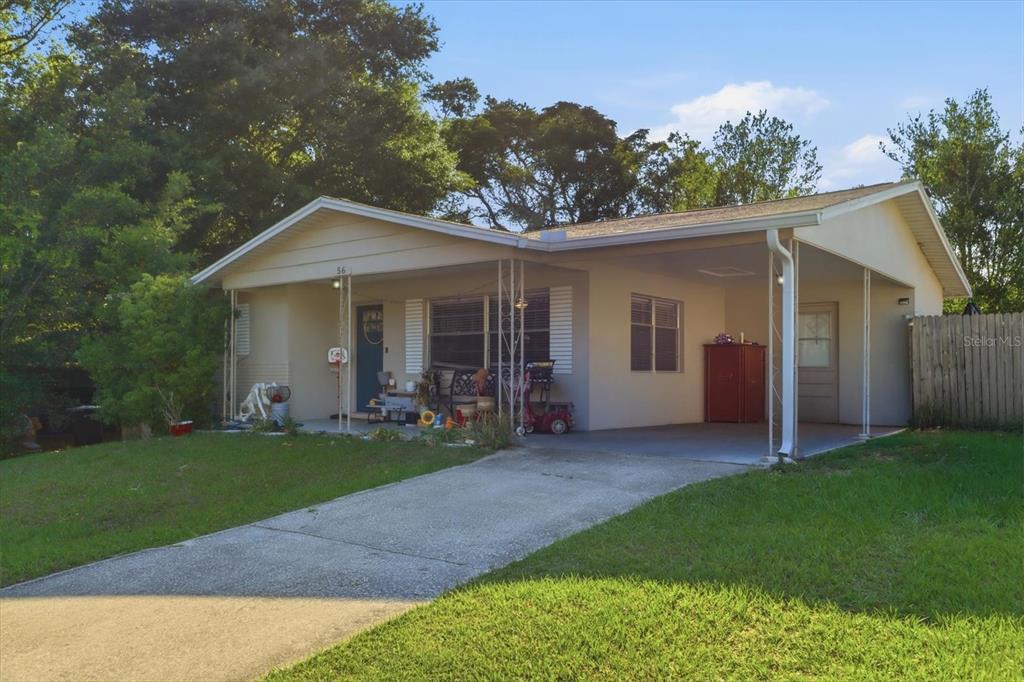 A single-story house with a concrete driveway, a front porch, and an attached carport — 56 S COLUMBUS STREET, BEVERLY HILLS, FL
