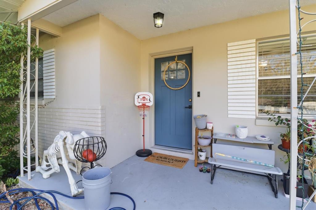 A front porch features a blue door, a small basketball hoop, and a skeleton decoration — 56 S COLUMBUS STREET, BEVERLY HILLS, FL