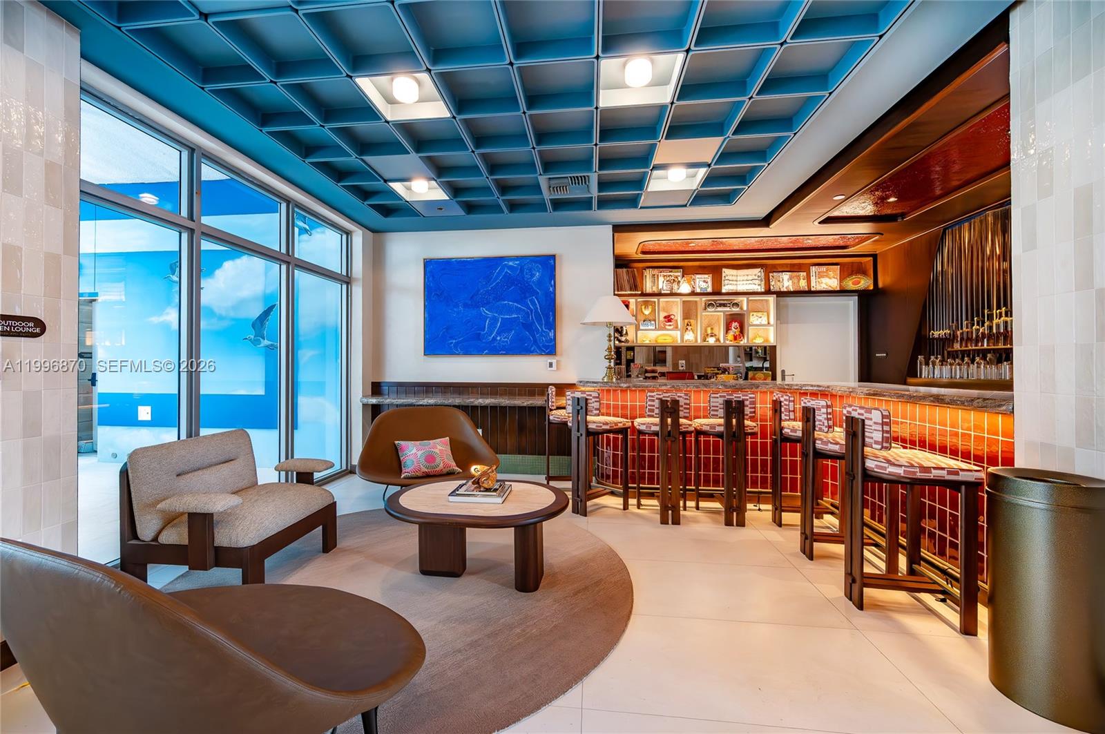 A lounge area features a blue coffered ceiling, a red-tiled bar, and modern furniture — 1611 SW 2nd Ave # 216, Miami FL 33129, MIAMI, FL