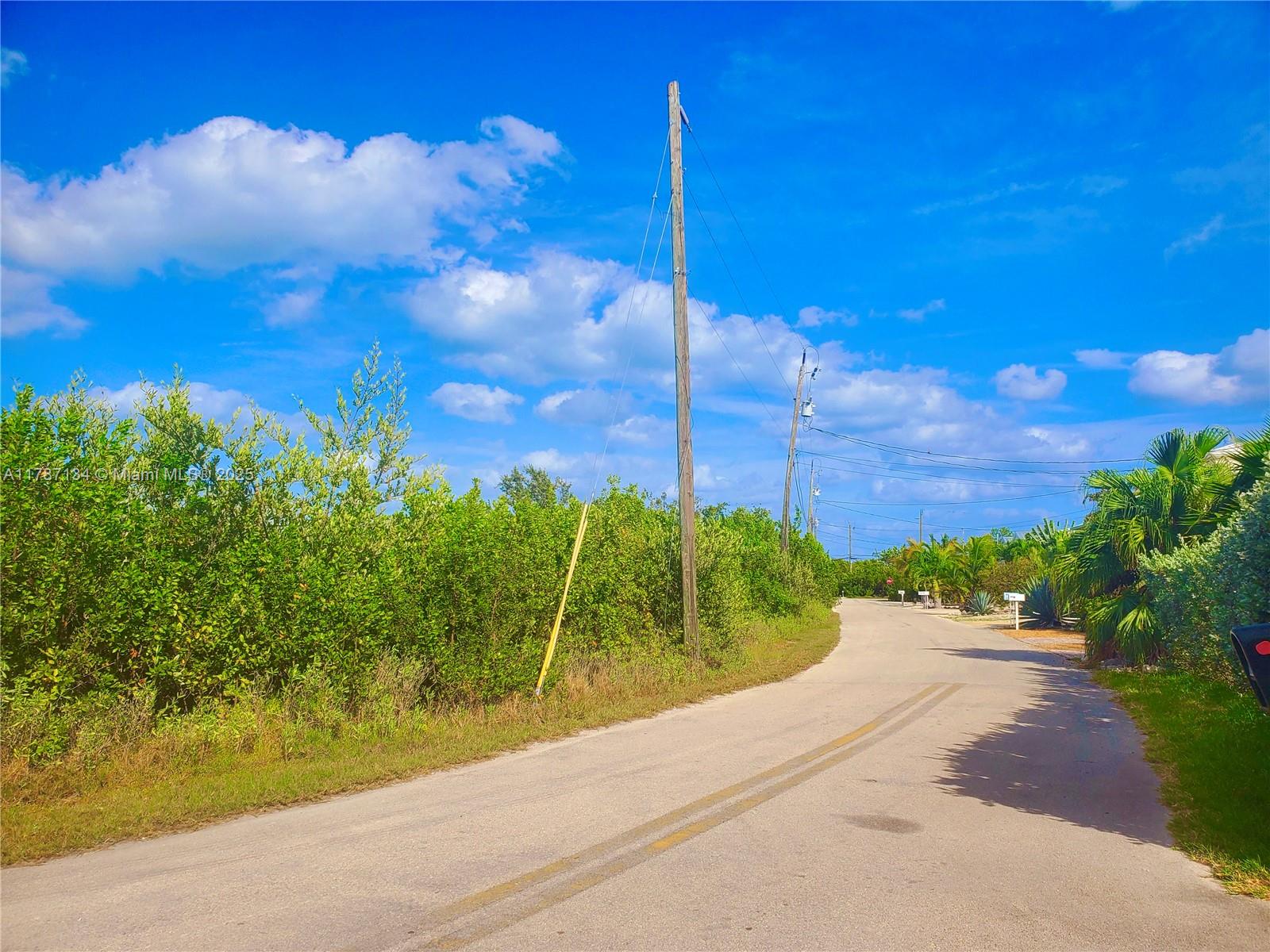 A paved road winds through a lush, green landscape under a bright blue sky — 0 Santa Barbara, Marathon FL 33050, MARATHON, FL