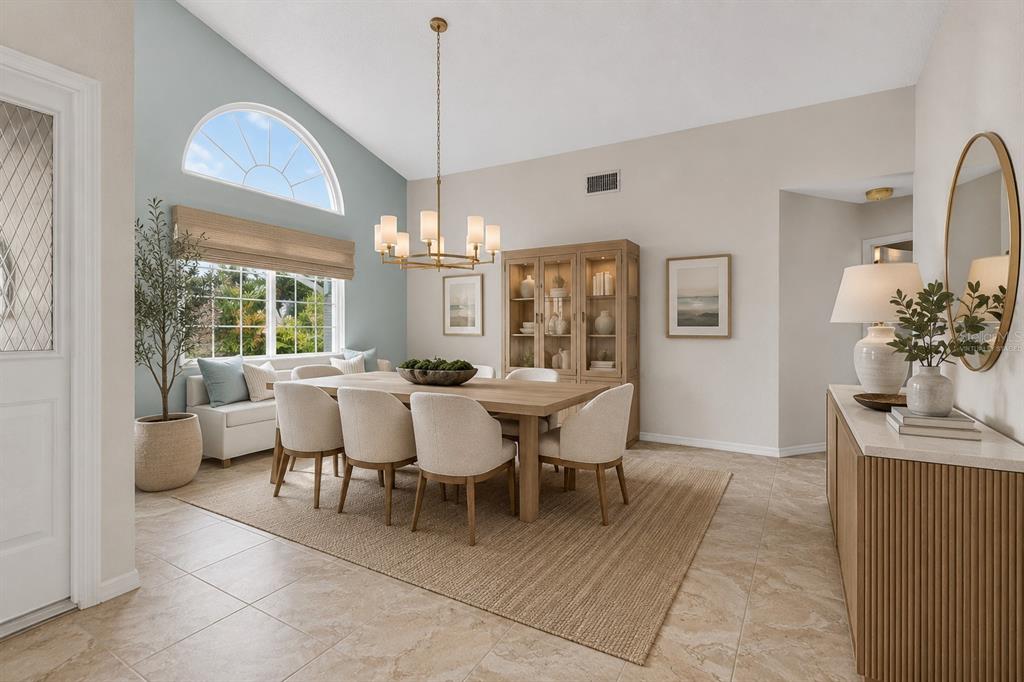 A living room features a vaulted ceiling, light blue walls, a fireplace, and tile flooring — 615 MONTE CRISTO BOULEVARD, ST PETERSBURG, FL