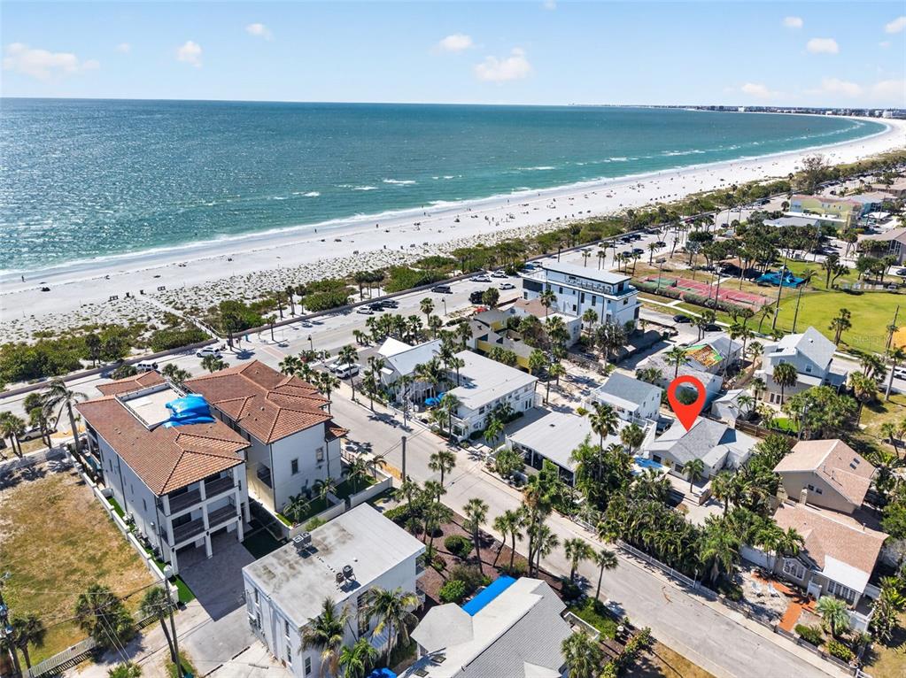 An aerial view shows a coastal neighborhood with a red pin marking a specific house — 107 14TH AVENUE, ST PETE BEACH, FL