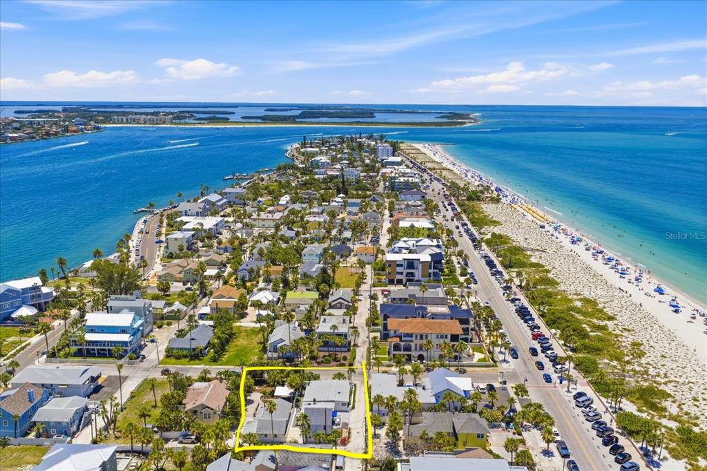 An aerial view shows a coastal neighborhood with a highlighted property near the beach — 107 14TH AVENUE, ST PETE BEACH, FL