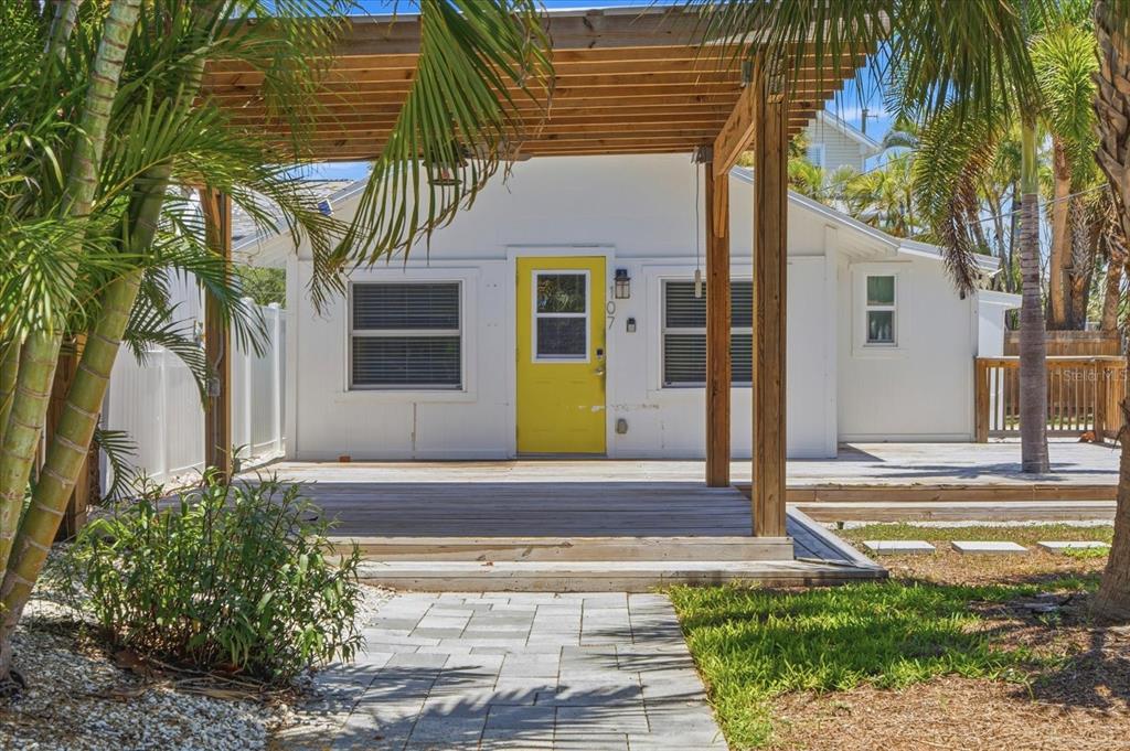 An aerial view shows a coastal neighborhood with a red location pin over a house — 107 14TH AVENUE, ST PETE BEACH, FL