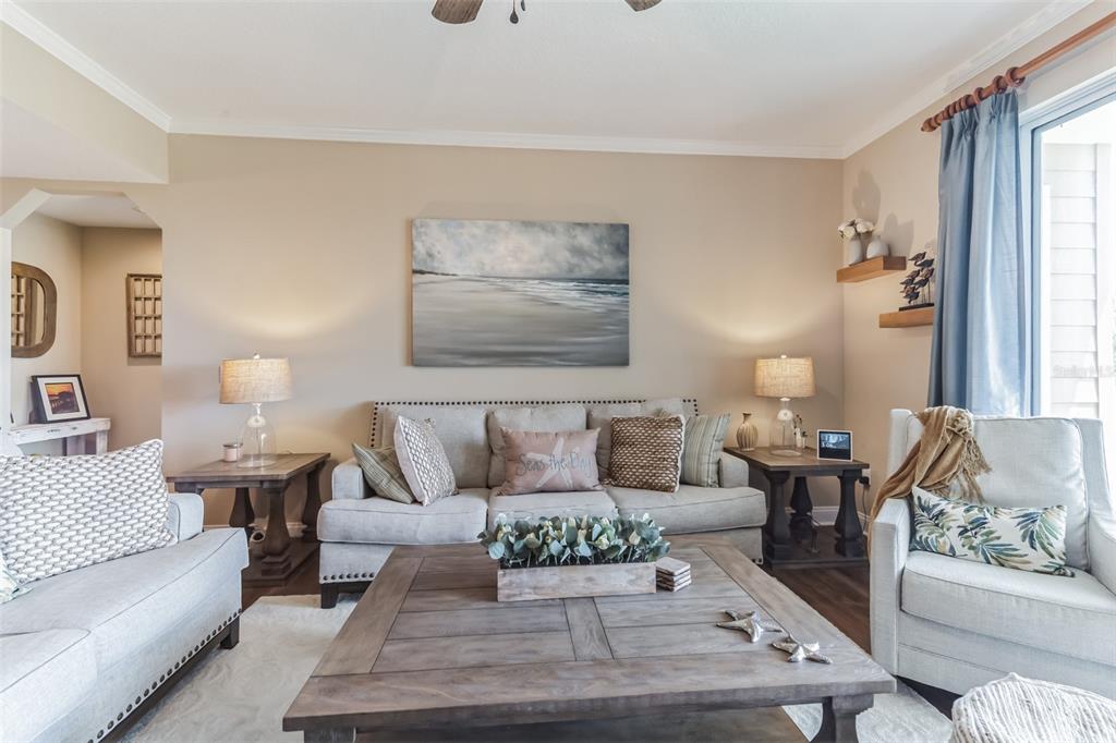 A living room features a light-colored sofa, a wooden coffee table, and coastal-themed decor — 4672 RIVERWALK VILLAGE COURT UNIT 8203, PONCE INLET, FL