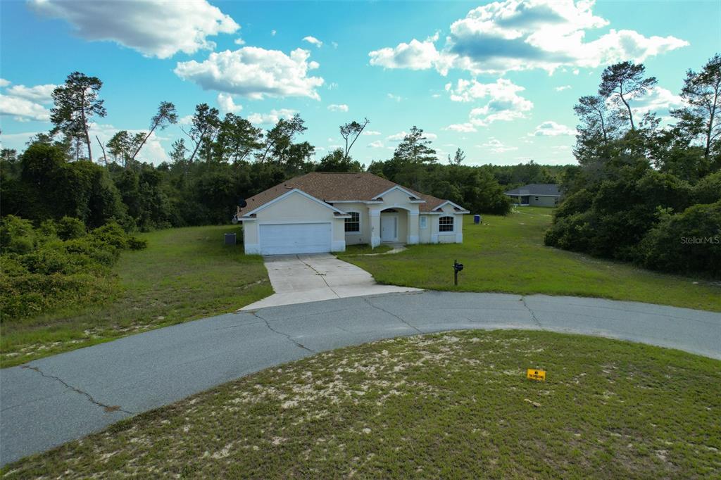 An aerial view shows a single-story house with a garage and driveway on a lot — 3858 SW 161ST STREET, OCALA, FL