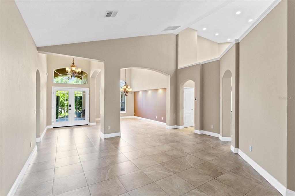 An aerial view shows three suburban houses with paved driveways and surrounding trees — 525 SADDLEWOOD LANE, WINTER SPRINGS, FL