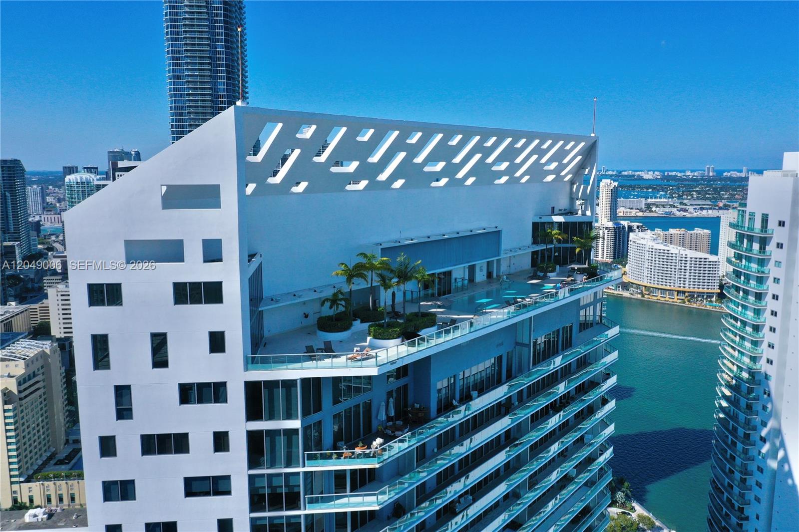 An aerial view shows the rooftop pool deck and architectural facade of a modern high-rise building — 1300 Brickell Bay Dr # 2509, Miami FL 33131, MIAMI, FL