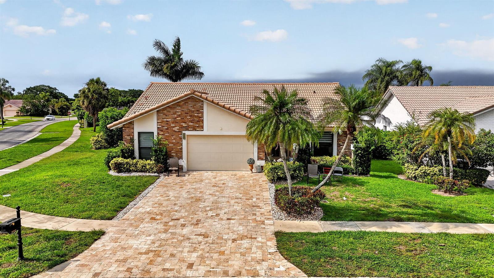 A single-story house with a brick facade, a tiled roof, and a paved driveway — 10065 Camelback Lane, Boca Raton FL 33498, BOCA RATON, FL