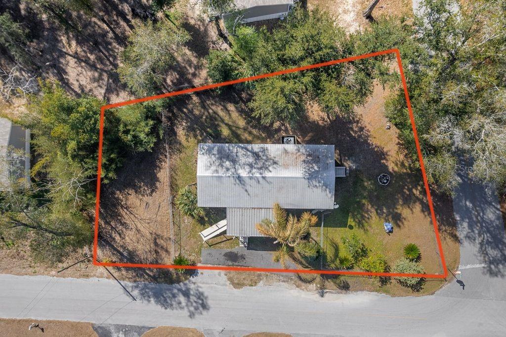 An aerial view shows a house on a lot outlined in red near a road — 16302 SE 57TH STREET, OCKLAWAHA, FL