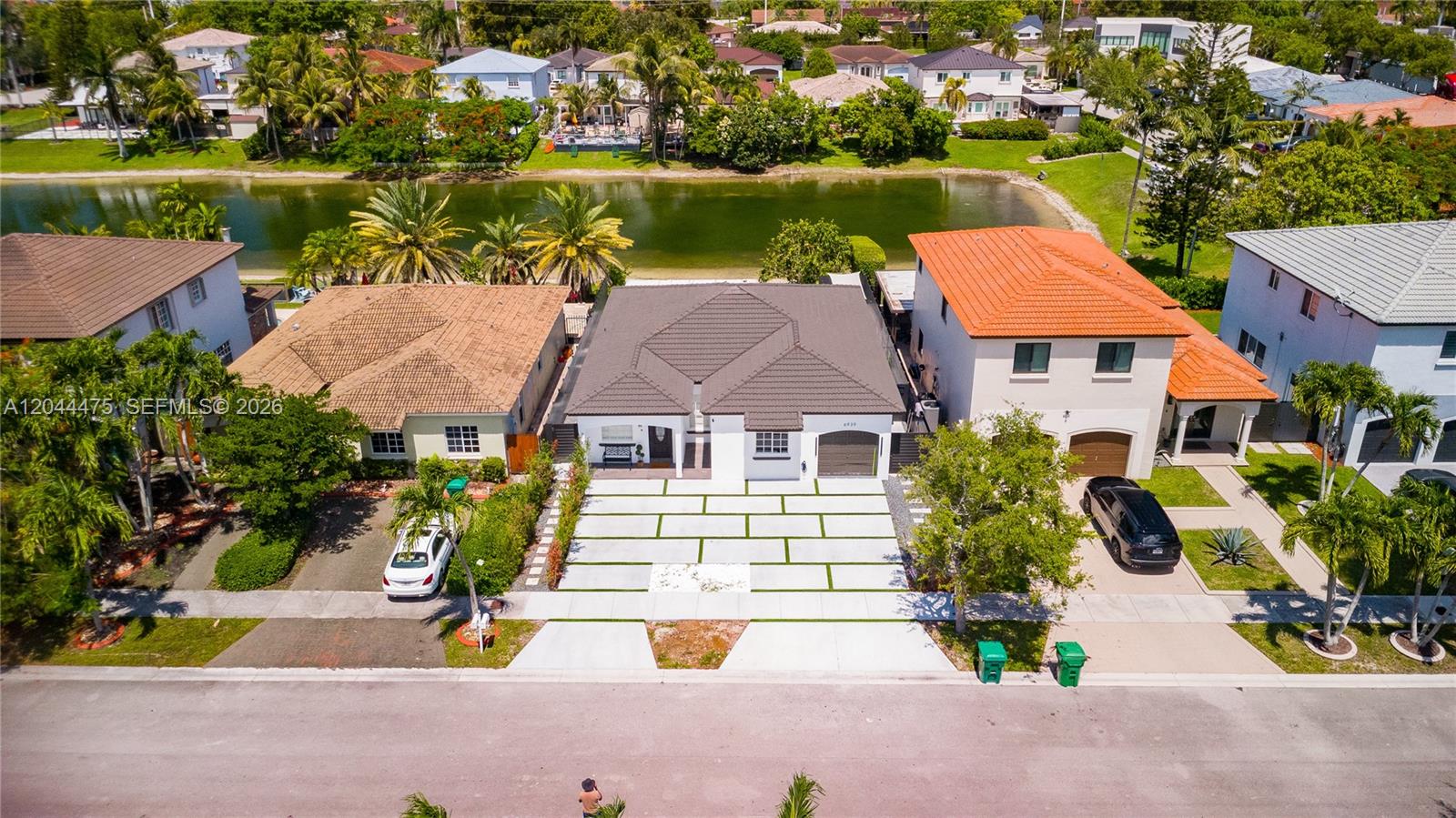 An aerial view shows a single-story house with a gray roof and a paved driveway — 6939 SW 158th Ave, Miami FL 33193, MIAMI, FL