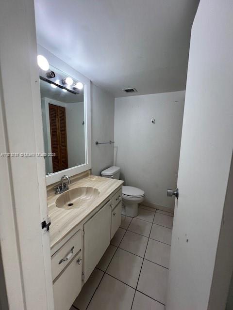 A bathroom features a vanity with a sink, a toilet, and tiled flooring — 13499 Biscayne Blvd # 602, North Miami FL 33181, NORTH MIAMI, FL