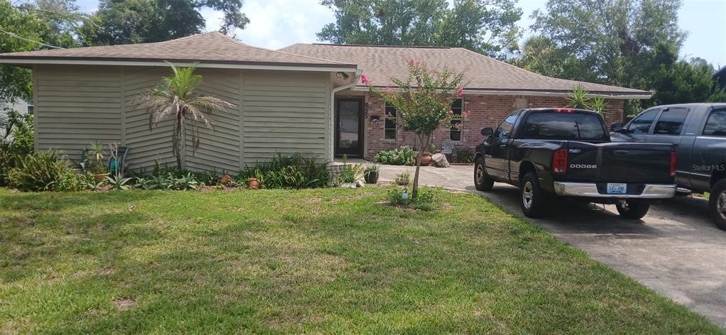 A single-story house features a brick and horizontal siding exterior with a concrete driveway — 855 N RIDGEWOOD AVENUE, ORMOND BEACH, FL