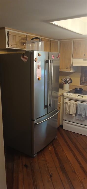 A stainless steel refrigerator stands in a kitchen with wooden cabinets and hardwood flooring — 855 N RIDGEWOOD AVENUE, ORMOND BEACH, FL