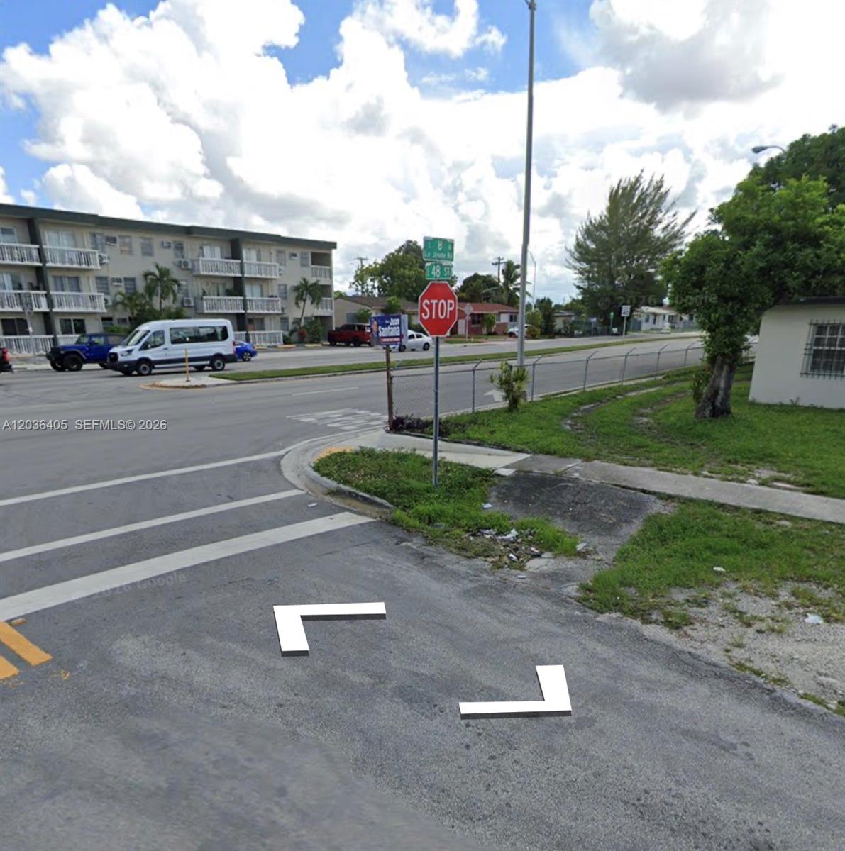 A street corner view shows a stop sign, a crosswalk, and a multi-story apartment building — 790 E 48th St, Hialeah FL 33013, HIALEAH, FL