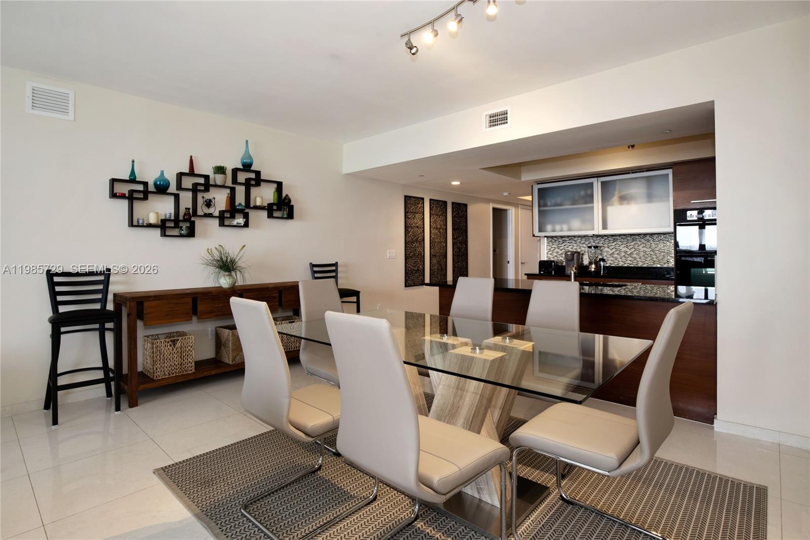 A dining room features a glass table, six beige chairs, and a wooden console table — 1830 S OCEAN DR # 3204, Hallandale Beach FL 33009, HALLANDALE BEACH, FL