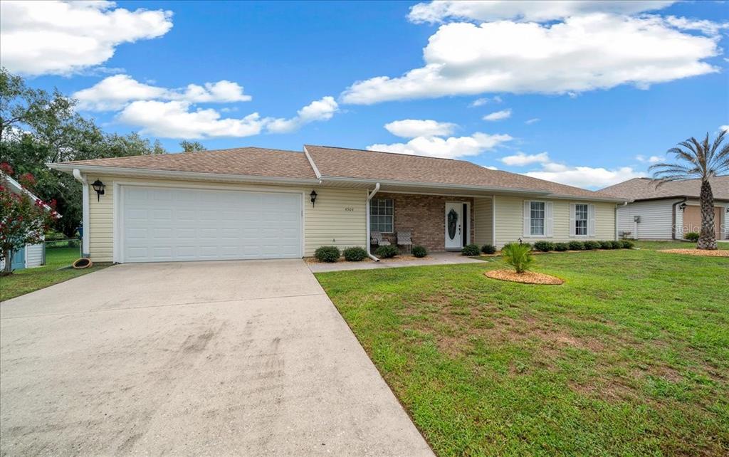 A single-story house with a two-car garage, brick facade, and a concrete driveway — 4504 NW 32ND STREET, OCALA, FL