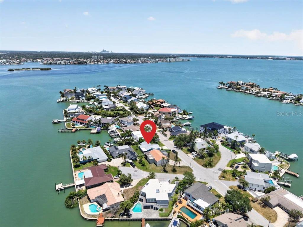 An aerial view shows a waterfront residential neighborhood with a red location marker — 819 59TH AVENUE, ST PETE BEACH, FL