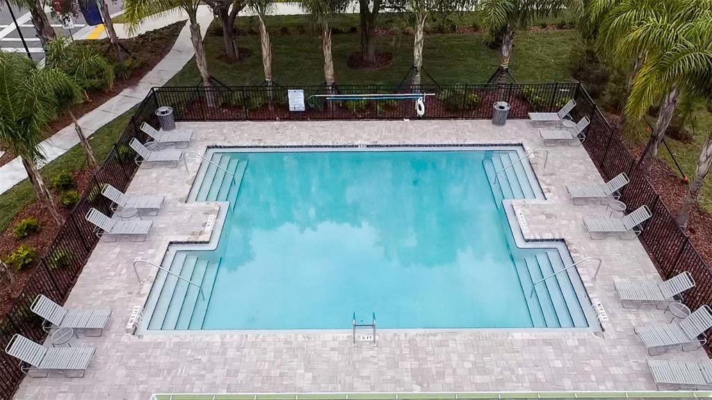 An aerial view of a rectangular swimming pool surrounded by lounge chairs and a fence — 2704 GOLDEN TROUT LANE, EDGEWATER, FL