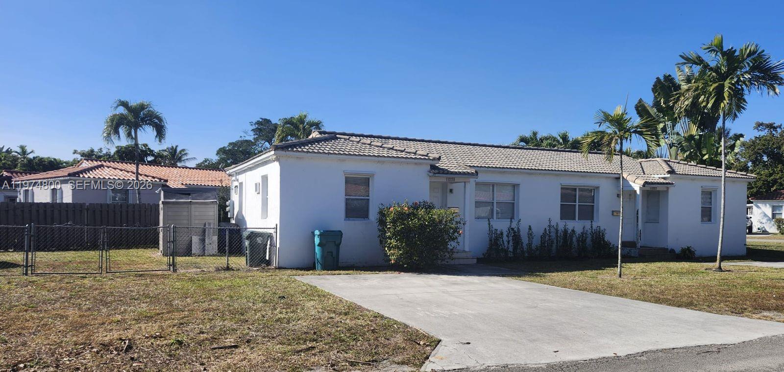 A white single-story house with a tiled roof and a concrete driveway — 11220 NE 11th Pl # 11220, Biscayne Park FL 33161, BISCAYNE PARK, FL