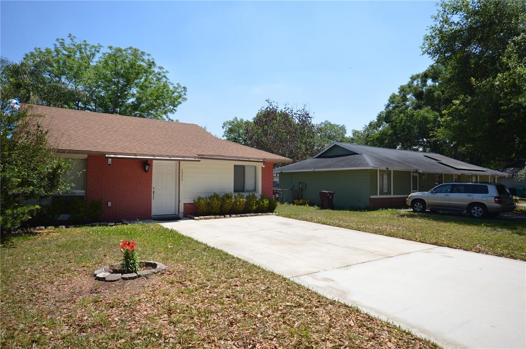 A single-story house with a red brick facade and a concrete driveway — 1397 CANDLEWYCK DRIVE, ORLANDO, FL