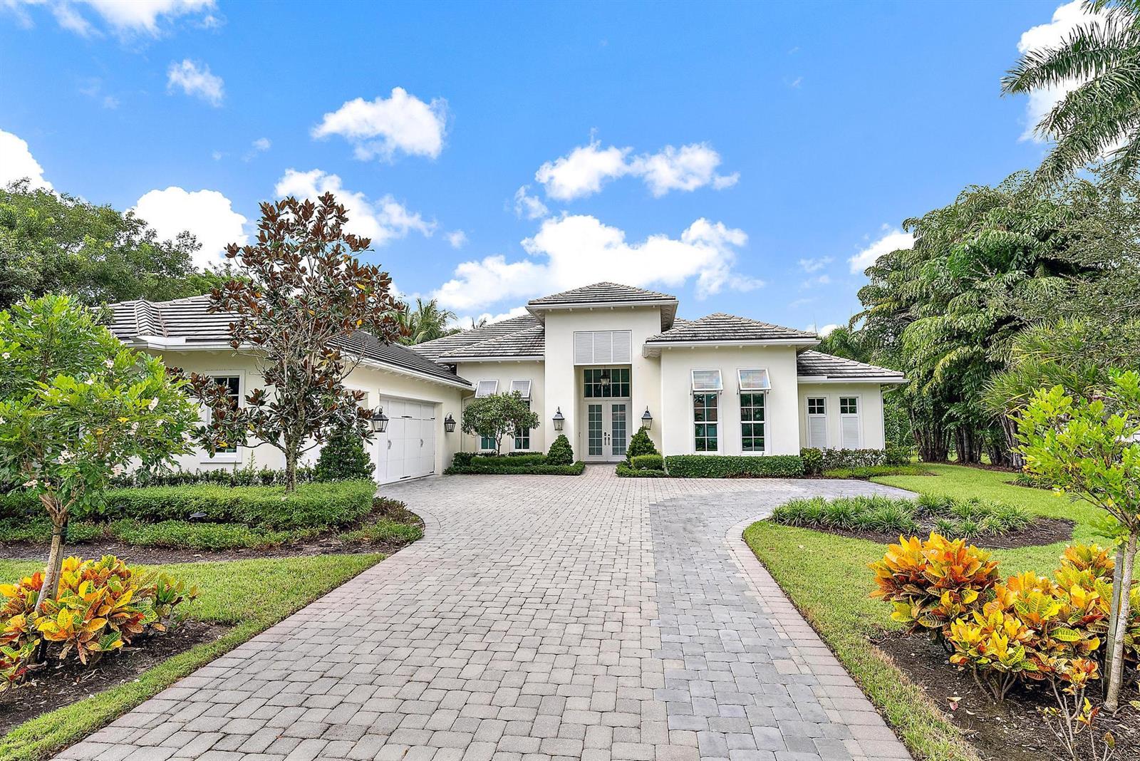 A single-story house with a paved driveway, white stucco exterior, and a tiled roof — 6081 Wildcat Run, West Palm Beach FL 33412, WEST PALM BEACH, FL