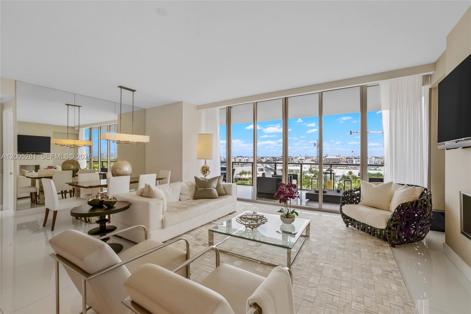 A bright living and dining area features white furniture, a glass coffee table, and balcony views — 9701 Collins Ave # 805S, Bal Harbour FL 33154, BAL HARBOUR, FL