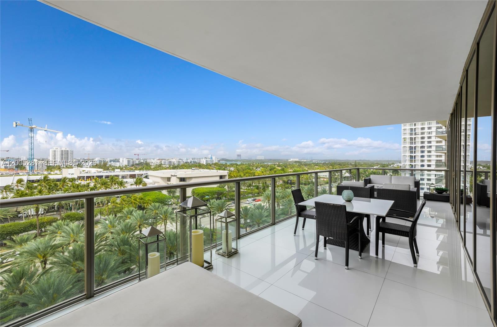 A high-rise balcony features a dining set, lounge seating, and a panoramic city view — 9701 Collins Ave # 805S, Bal Harbour FL 33154, BAL HARBOUR, FL