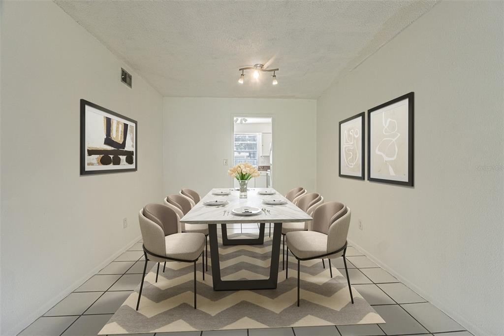 A dining room features a marble-topped table with eight chairs on a chevron-patterned rug — 7517 ABONADO ROAD UNIT 7517, TAMPA, FL