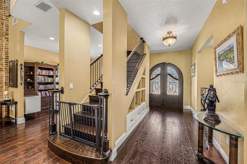 A large tan stucco house with a three-car garage and a paved driveway — 2179 ARNOLD PALMER DRIVE, TITUSVILLE, FL