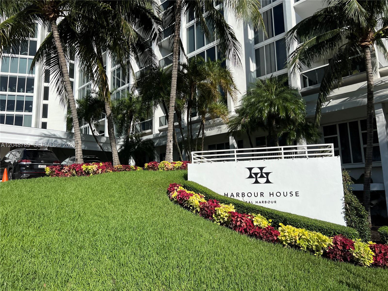 A white sign for Harbour House sits on a grassy hill in front of a building — 10275 Collins Ave # 112, Bal Harbour FL 33154, BAL HARBOUR, FL