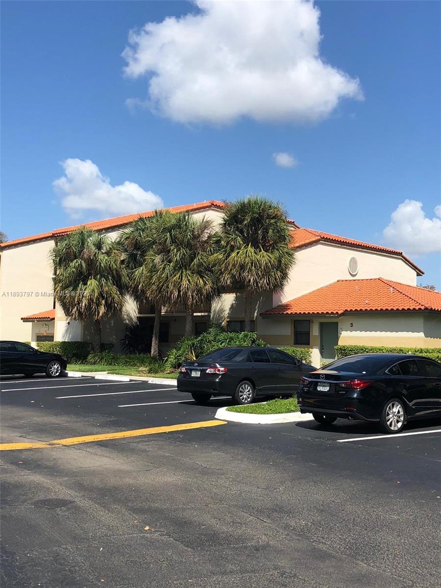 A two-story apartment building with a tile roof and palm trees in the parking lot — 9861 Nob Hill Ct # 9861, Sunrise FL 33351, SUNRISE, FL