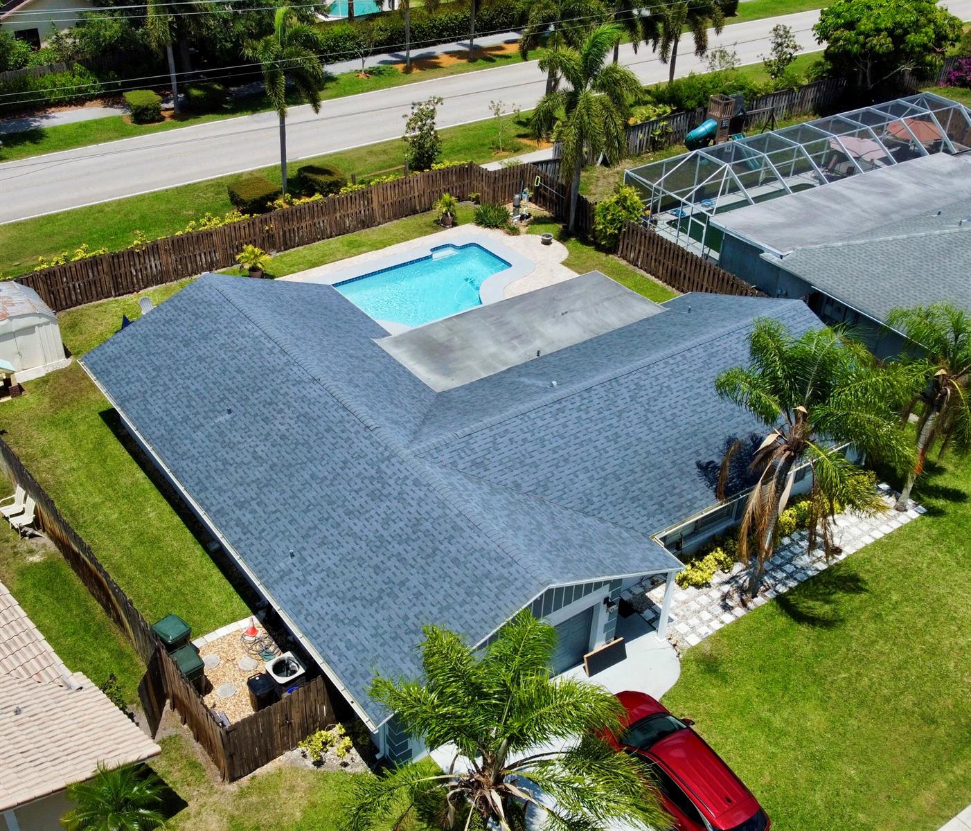 A living room features a stone fireplace, a large sectional sofa, and wood-look tile flooring — 1381 Wyndcliff, Wellington FL 33414, WELLINGTON, FL