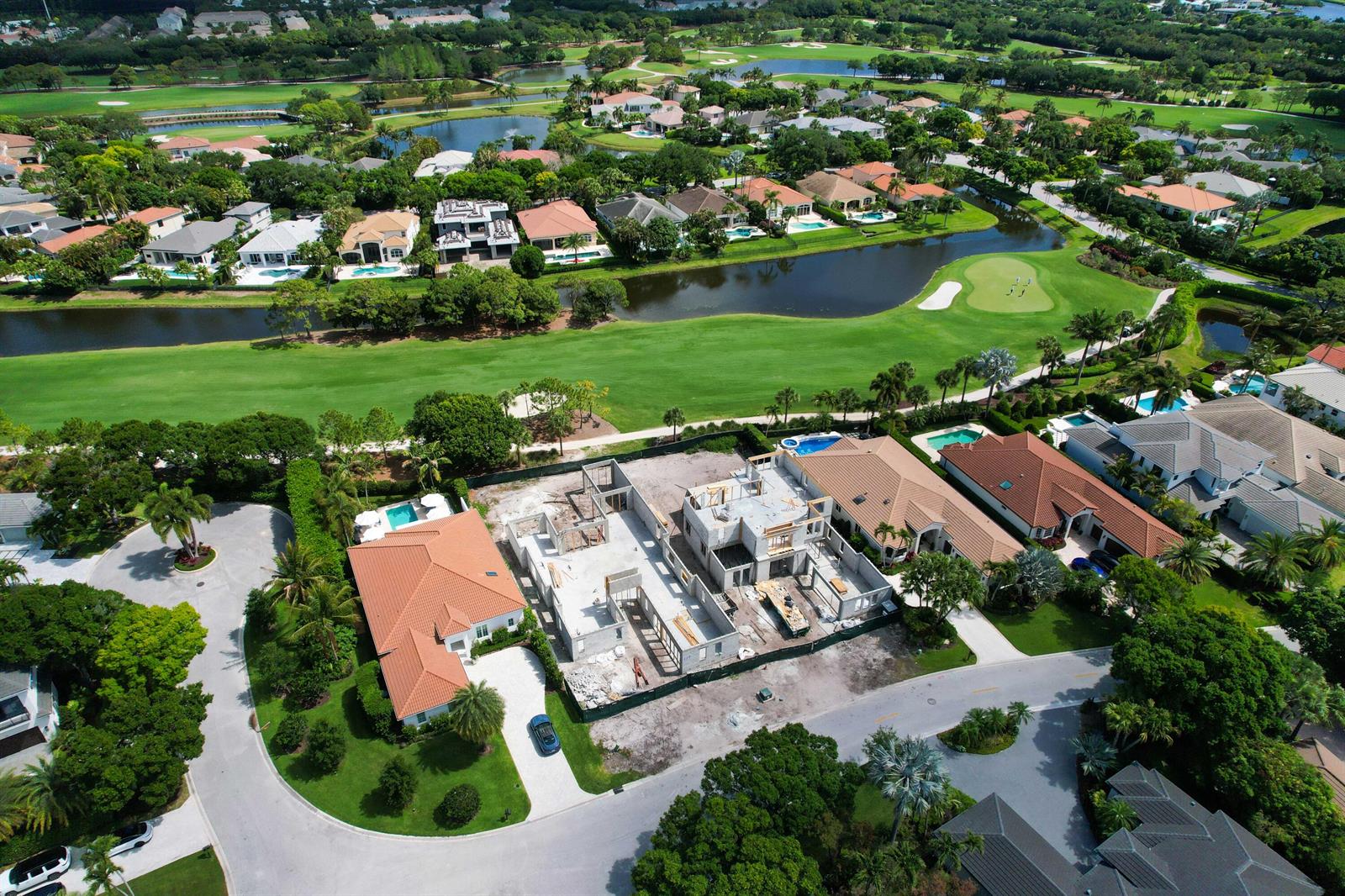 An aerial view shows a residential neighborhood with a house under construction on a golf course — 117 W Village Way, Jupiter FL 33458, JUPITER, FL