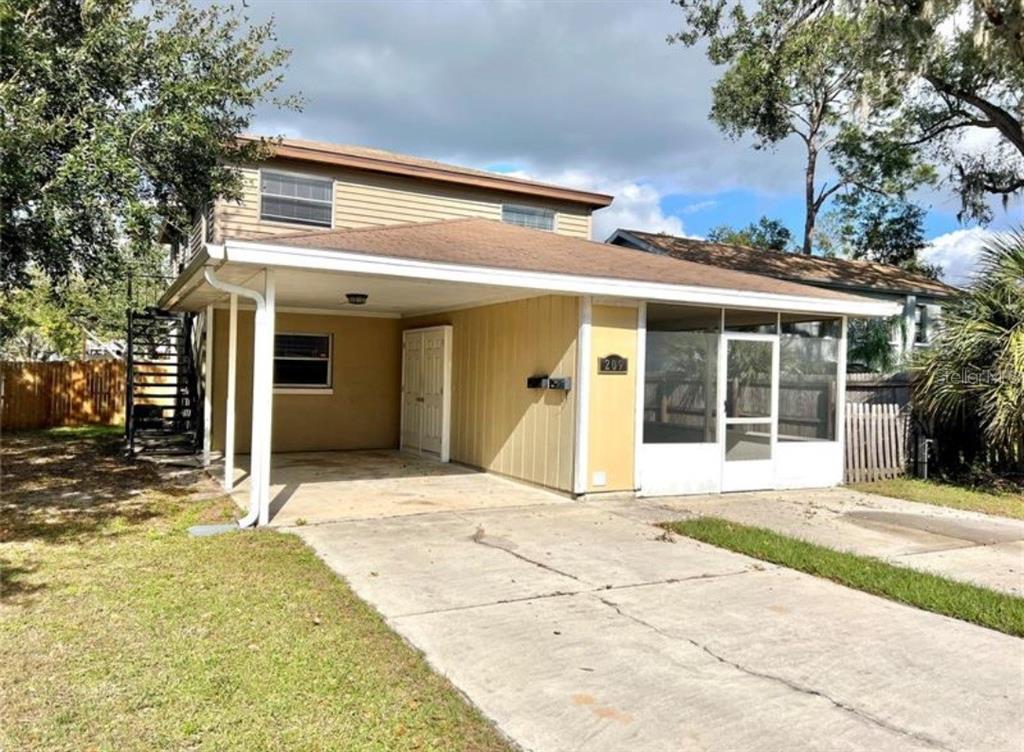 A two-story house with a carport, a screened-in porch, and an exterior metal staircase — 209 AVENUE B SE, WINTER HAVEN, FL
