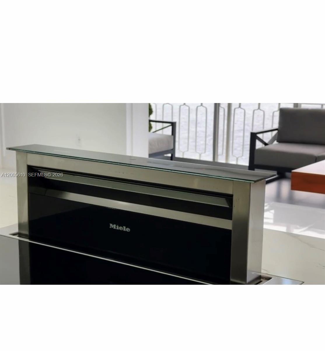 A Miele downdraft ventilation hood is extended upward from a kitchen countertop — 11111 biscayne blvd # 1815, Miami FL 33181, MIAMI, FL