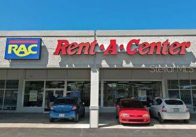 The exterior of a Rent-A-Center retail store features a blue and red sign — 90 ALONDRA ST., SAN JUAN, PR