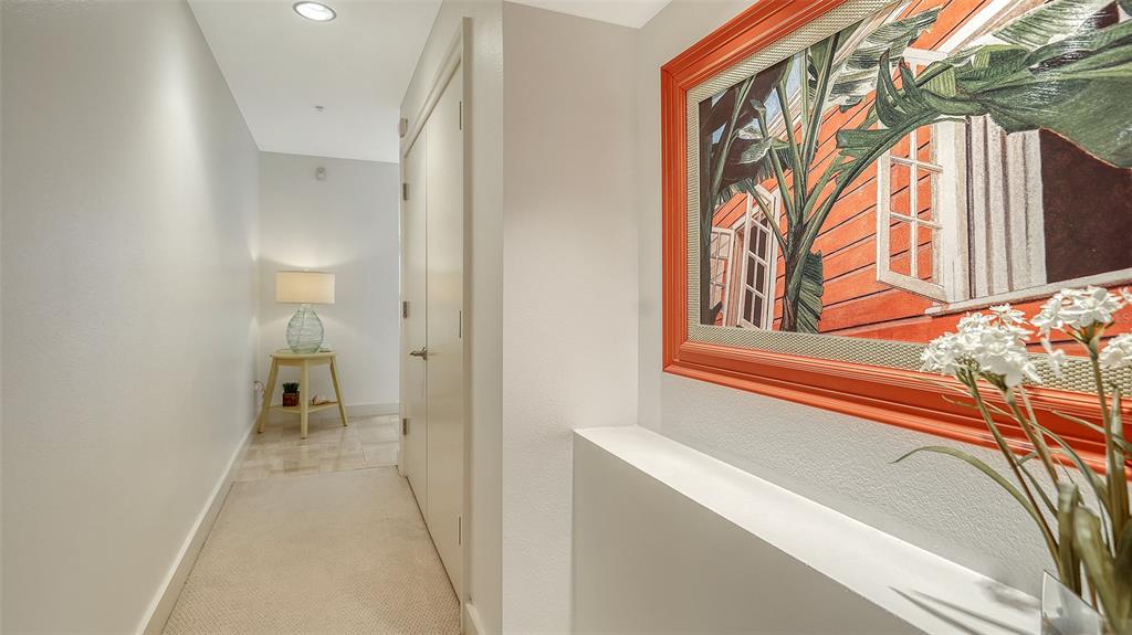 A hallway features a beige carpet, a framed painting, and a small table with a lamp — 4561 GULF OF MEXICO DRIVE UNIT 202, LONGBOAT KEY, FL