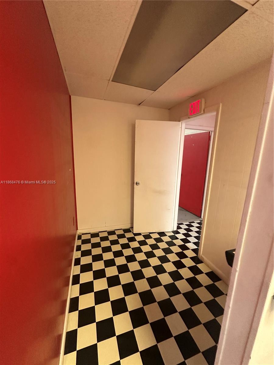 A small room features a black and white checkered floor and a red wall — 4115 NW 132nd St, Opa-Locka FL 33054, OPA-LOCKA, FL