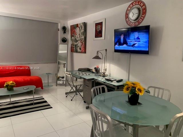 A living and dining area features a red sofa, glass desk, and round glass table — 100 LINCOLN RD # 1509, Miami Beach FL 33139, MIAMI BEACH, FL