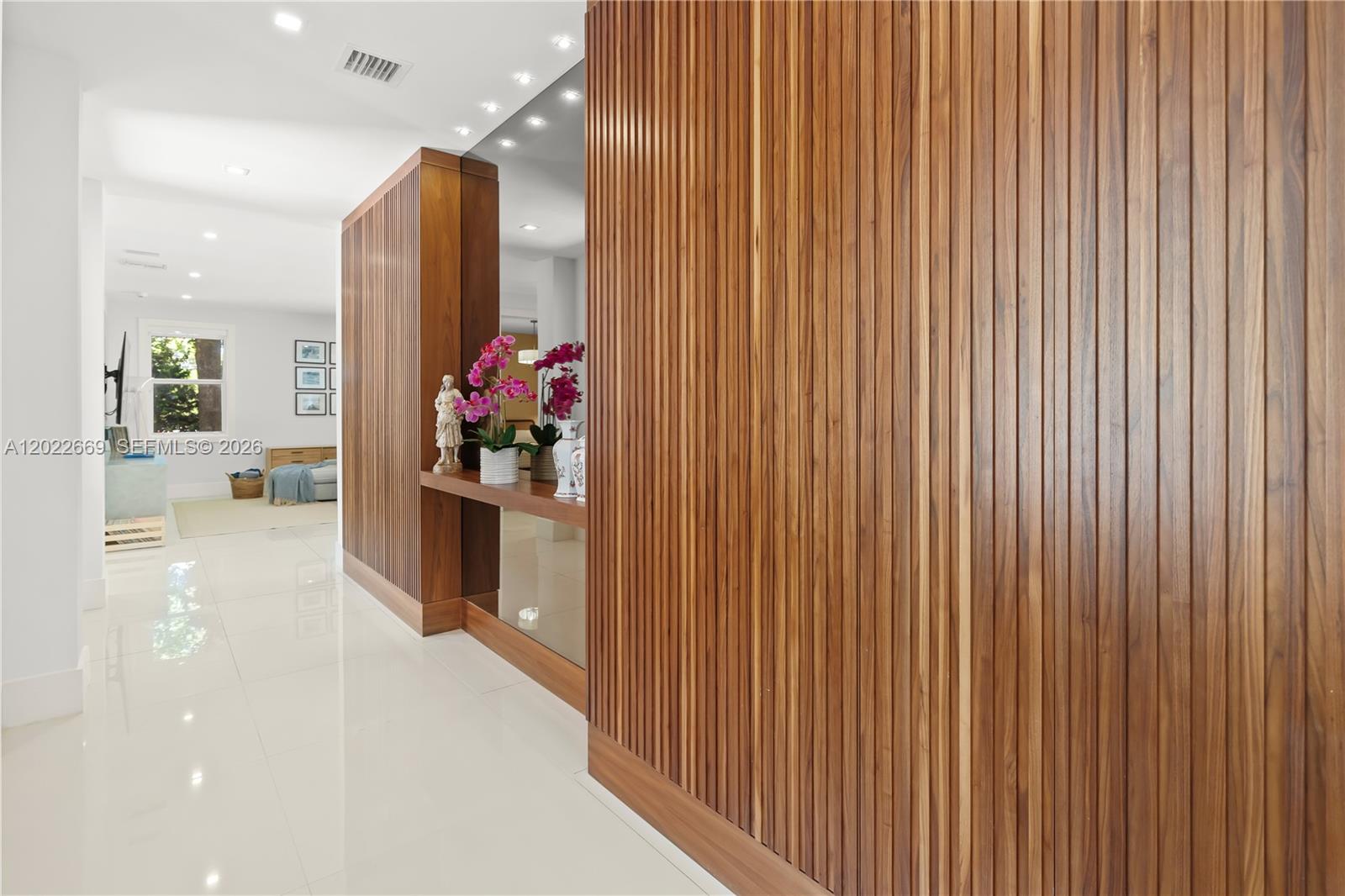 A hallway features white tile floors and a wall paneled with vertical wood slats — 5700 SW 86th St, South Miami FL 33143, SOUTH MIAMI, FL