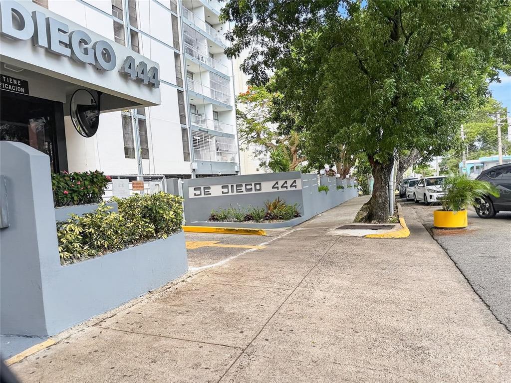 A view of the exterior entrance and sidewalk of a multi-story apartment building — 444 CONDOMINIO DE DIEGO UNIT 1503, SAN JUAN, PR
